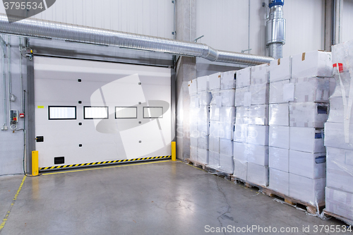 Image of warehouse door or gate and cargo boxes