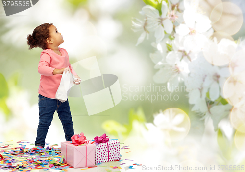 Image of happy little baby girl with birthday presents