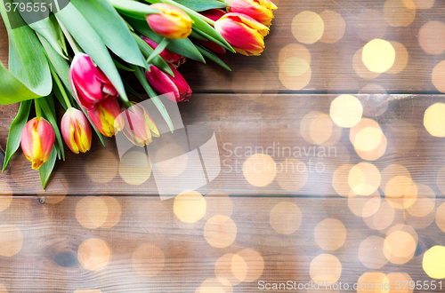 Image of close up of tulip flowers on wooden table