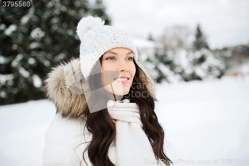 Image of happy woman outdoors in winter clothes