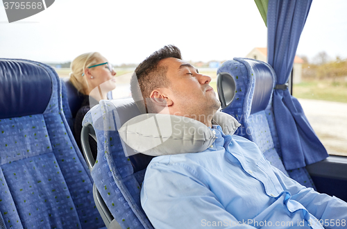 Image of man sleeping in travel bus with cervical pillow