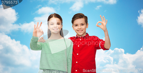 Image of happy boy and girl showing ok hand sign