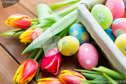 Image of close up of colored easter eggs and flowers