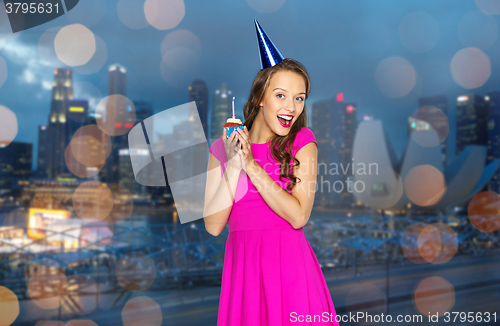 Image of happy woman or teen girl with birthday cupcake