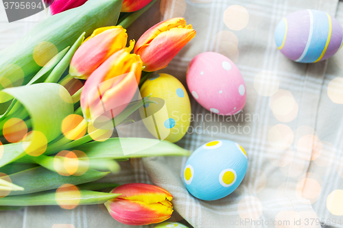 Image of close up of colored easter eggs and flowers