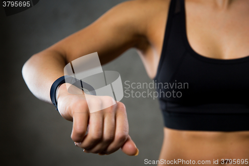 Image of woman with heart-rate watch in gym