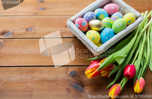 Image of close up of colored easter eggs and flowers