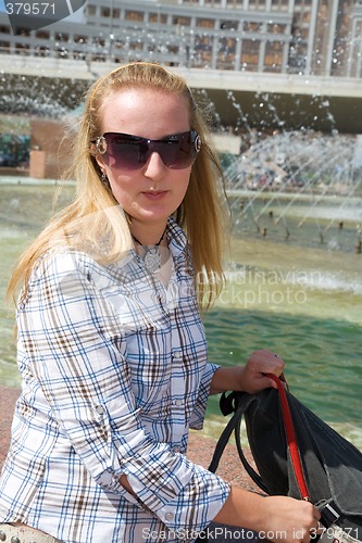 Image of Girl near city fountain.