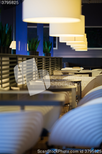 Image of Restaurant with empty tables and chairs