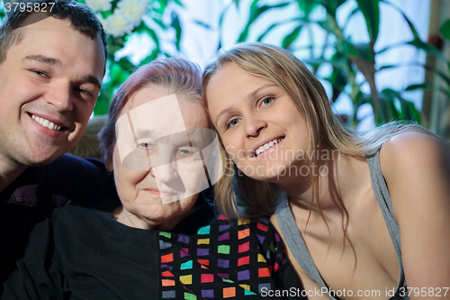 Image of Happy couple posing with grandma