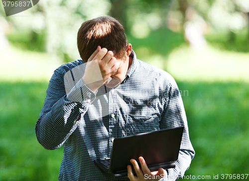 Image of Middle-aged man with laptop