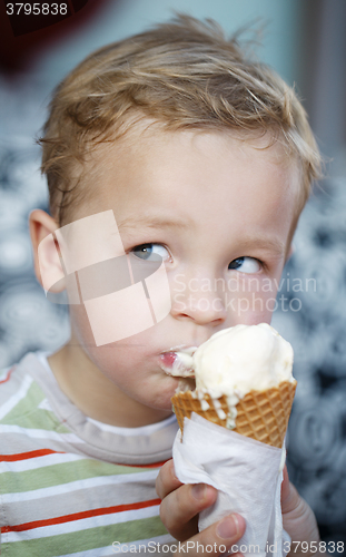 Image of Cute little boy eating an ice cream cone