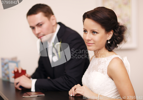 Image of Couple at a reception desk with their passports