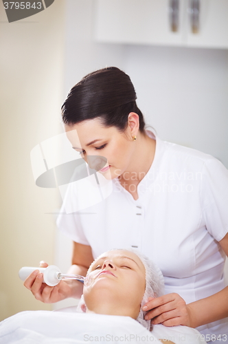 Image of Woman under anti-aging therapy at beauty treatment salon