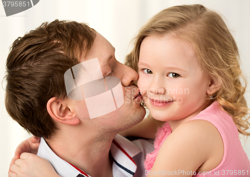 Image of Daddy kissing beautiful little daughter