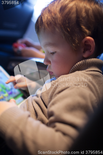 Image of Little boy playing on a tablet computer