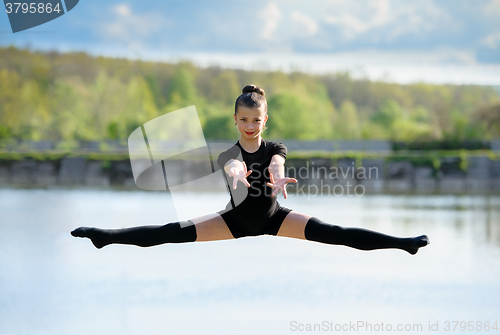 Image of Young Gymnast is Up in the Air Doing Leg-Split