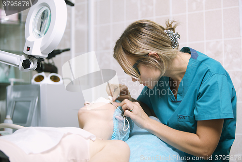 Image of Beautician in a skin clinic with patient