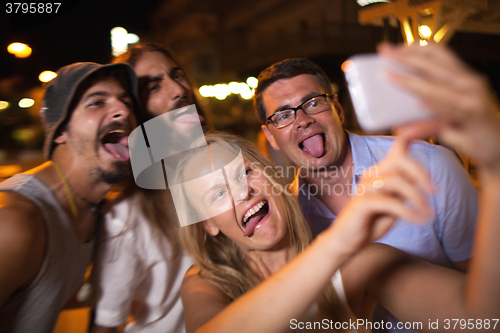 Image of Young people taking crazy selfie with mobile