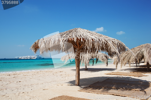 Image of Straw beach umbrellas at a tropical resort