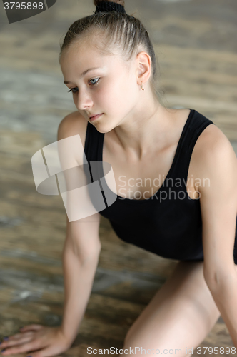 Image of Ballet dancer stretching on the floor