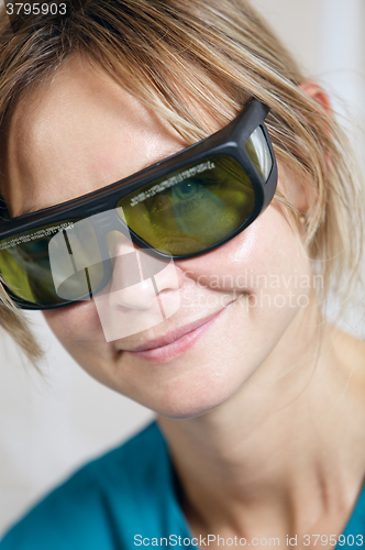 Image of Smiling therapist in protective goggles