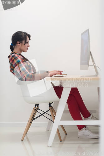 Image of startup business, woman  working on desktop computer