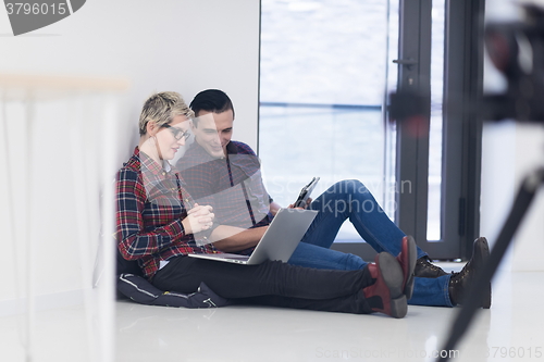 Image of startup business, couple working on laptop computer at office