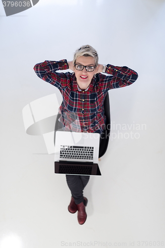 Image of top view of young business woman working on laptop computer