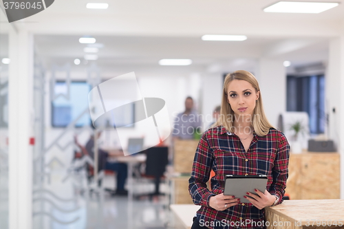 Image of portrait of young business woman at office with team in backgrou