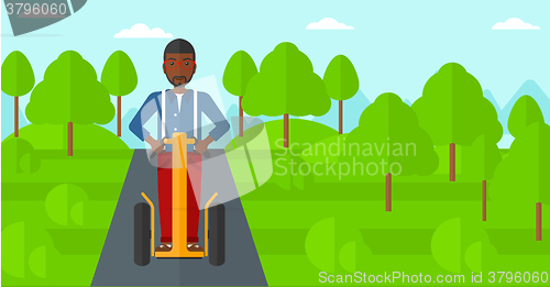 Image of Man riding on electric scooter.