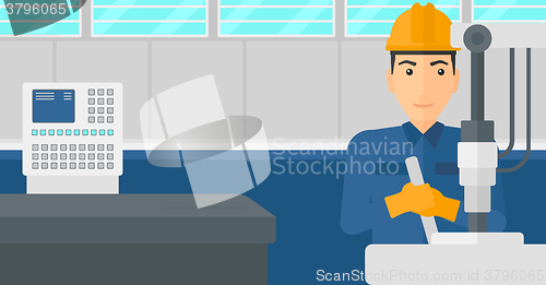 Image of Man working with industrial equipment.