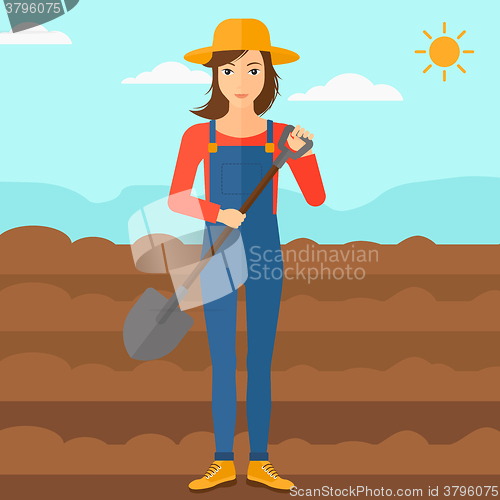 Image of Farmer on the field with shovel.