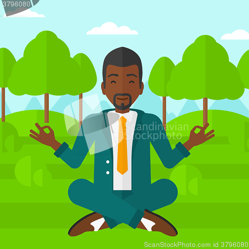 Image of Businessman meditating in lotus pose.