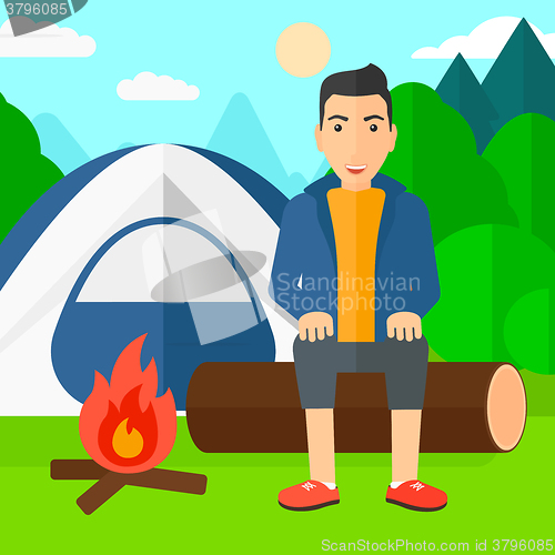 Image of Man sitting at camp.