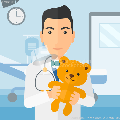 Image of Pediatrician holding teddy bear.