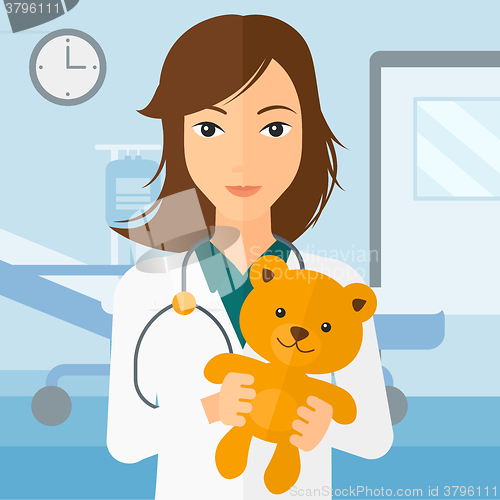 Image of Pediatrician holding teddy bear.