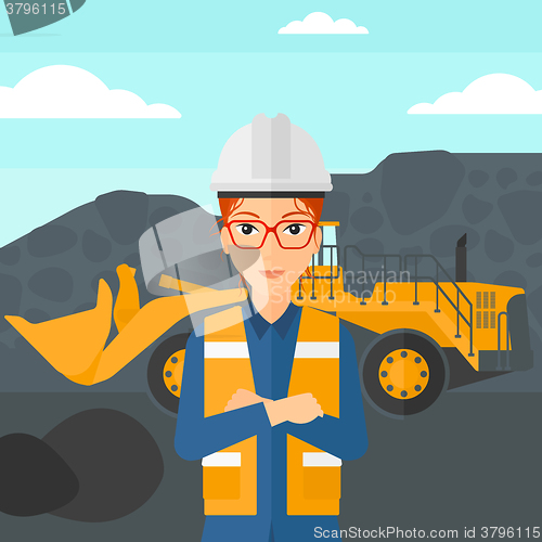 Image of Miner with mining equipment on background.