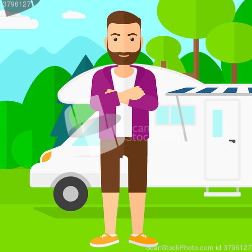 Image of Man standing in front of motor home.