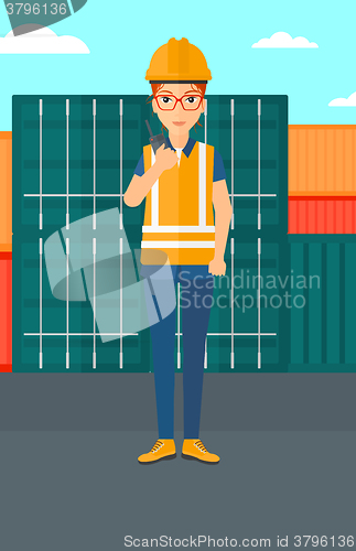 Image of Stevedore standing on cargo containers background.