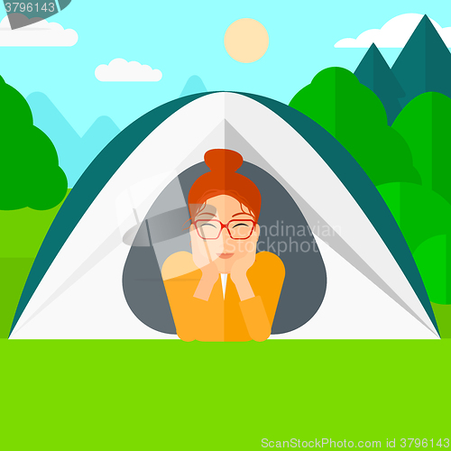 Image of Woman lying in tent.