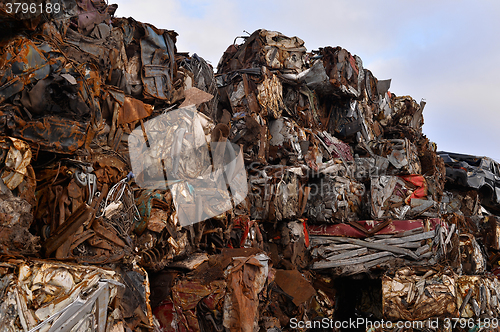 Image of A pile of compressed cars in blocks for processing