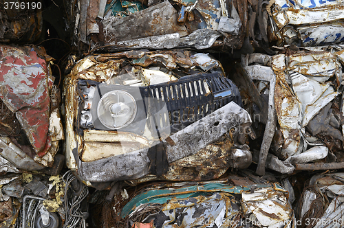 Image of A pile of compressed cars in blocks for processing