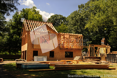 Image of A residential home under construction mid framing and sheathing