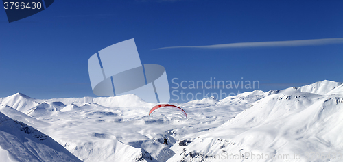 Image of Panoramic view on sky gliding in snowy mountains