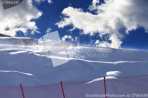 Image of Off-piste slope during a blizzard and sunlight blue sky