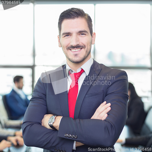 Image of Team leader with coworkers working in office.