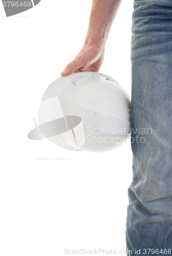 Image of Male engineer in jeans holding white hardhat