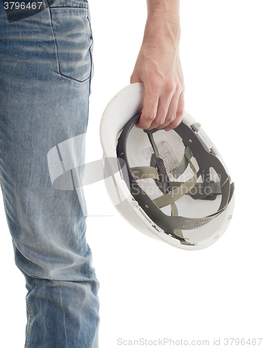 Image of Male engineer in jeans holding white hardhat