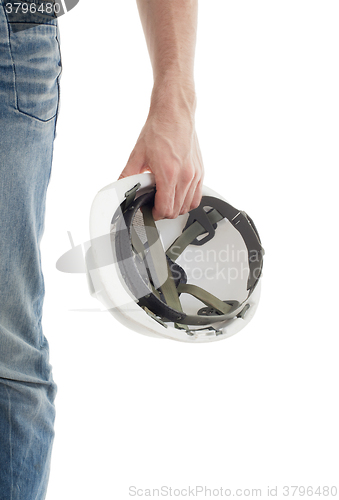 Image of Male engineer in jeans holding white hardhat